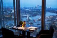 a table in a room with a view of a city at Shangri-La The Shard, London in London