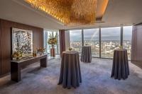 a room with two tables and a large window at Shangri-La The Shard, London in London