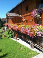 a house with flowers on the side of it at Ferienhaus Ematberg in Niedernsill