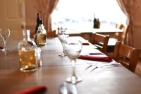 a wooden table with two wine glasses on it at The Ilchester Arms Hotel, Ilchester Somerset in Ilchester