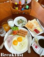 a plate of breakfast food with eggs and bread on a table at Koh Chang Bailan Beach Resort in Ko Chang