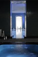 a blue room with a door leading to a pool at Hotel C2 in Marseille