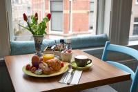 a table with a plate of breakfast food on it at Bed &amp; Breakfast Hotel Malts in Haarlem