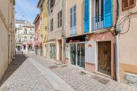 an empty street in a city with colorful buildings at Le Nani Raou par Dodo à Cassis in Cassis