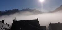 a view of a foggy valley with mountains in the background at superbe grange rénovée in Grust
