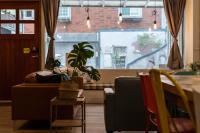 a living room with a couch and a table with a plant at Cozy House Hostel in Hualien City