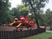 a playground with a slide in a park at Mimi Apartment in Nyíregyháza