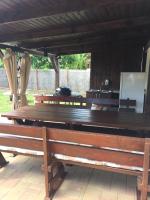 a group of wooden benches sitting under a pavilion at Mimi Apartment in Nyíregyháza