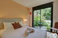 a bedroom with a white bed with a large window at Villa Paloma 4 étoiles avec Piscine et Vue exceptionnelle sur l&#39;ocean à Saint-Leu in Saint-Leu