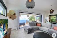 a living room with a couch and a view of the ocean at Villa Paloma 4 étoiles avec Piscine et Vue exceptionnelle sur l&#39;ocean à Saint-Leu in Saint-Leu