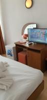 a bedroom with a bed and a desk with a computer on it at Hotel Prahova in Saturn