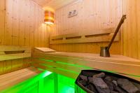a sauna with a tub with a pot of rocks at Sissi Park in Lachtal