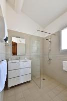 a white bathroom with a sink and a shower at Les Mazets de Marie de Jules in Eyragues