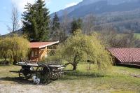 a picnic table in a field next to a cabin at chalet du camping la Porte St Martin in Saint-Martin-en-Vercors