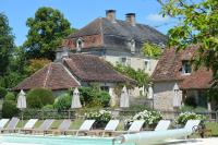 a house with chairs and a pool in front of it at Manoir de Malagorse in Cuzance