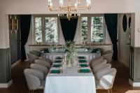 a dining room with a white table and chairs at Hotel Toscania in Włoszakowice
