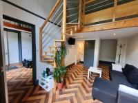 a living room with a couch and a staircase at Pavillon Kalensa in Vals-les-Bains