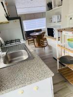 a kitchen with a sink and a counter top at Mobil-home 4 personnes 400m de la mer in Berck-sur-Mer