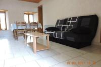 a living room with a couch and a table at Gite au pied du mont Lozère 2 in Mas-dʼOrcières