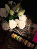 a table with a vase of roses and glasses of wine at Luxe et Calme en Hyper Centre - La Cour des Bois in Lyon