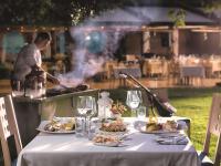 a table with plates of food on it with a grill at Swissotel Buyuk Efes Izmir in Izmir