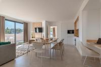 a kitchen and dining room with a table and chairs at Lagrange Apart&#39;Hôtel Antibes Olympie in Antibes