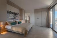 a bedroom with a bed and a view of the ocean at Lagrange Apart&#39;Hôtel Antibes Olympie in Antibes