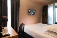 a hotel room with a bed and a desk and a tv at Best Western Quartier Latin Pantheon in Paris