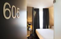 a hotel room with a bed and a sign on the wall at Best Western Quartier Latin Pantheon in Paris