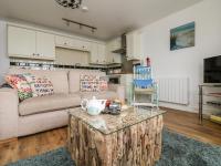 a living room with a couch and a coffee table at Sennen Heights in Sennen Cove