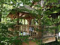 a wooden gazebo in the middle of trees at Cabane Perchée Spa Dordogne La Ferme de Sirguet in Monsac