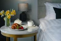 a plate of food on a table next to a bed at Original Boutique Hotel in Tbilisi City
