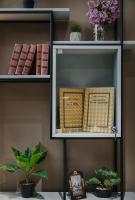 a book shelf with books on it with plants at Original Boutique Hotel in Tbilisi City