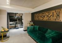 a living room with a green couch and a black wall at Original Boutique Hotel in Tbilisi City