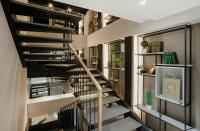 a spiral staircase in a house with bookshelves at Original Boutique Hotel in Tbilisi City