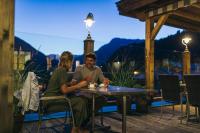 a man and woman sitting at a table on a patio at Feelfree Nature Resort in Oetz