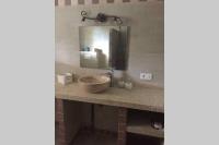 a bathroom with a sink and a mirror at Suite spacieuse avec accès piscine in Ghisonaccia