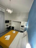a bedroom with a large bed with towels on it at Acquarium Tropea in Tropea