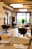 a dining room with wine glasses on a table at Hostal Restaurant Roma in Cubells