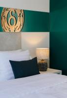 a bedroom with a bed and a green and white wall at Original Boutique Hotel in Tbilisi City