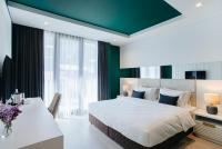 a bedroom with a large bed and a desk at Original Boutique Hotel in Tbilisi City