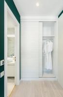 a bathroom with a sliding glass door with a robe at Original Boutique Hotel in Tbilisi City