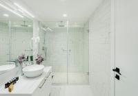 a white bathroom with a sink and a shower at Original Boutique Hotel in Tbilisi City