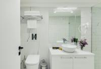 a white bathroom with a sink and a toilet at Original Boutique Hotel in Tbilisi City