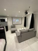 a living room with two couches and a flat screen tv at Lh Rooms Location in Le Havre
