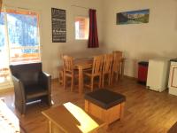 a living room with a dining room table and chairs at Appartement de 2 chambres avec vue sur la ville piscine partagee et terrasse a La foux d&#39;Allos in La Foux