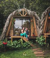 a man and a woman sitting in a tree house at Bodhi Santa Catalina in Santa Catalina