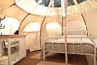 a bedroom with a bed in a tent at Glamping at Camping La Source in Saint-Pierre-dʼArgençon