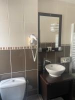 a bathroom with a toilet and a sink and a mirror at The Originals Boutique, Hôtel d&#39;Angleterre, Le Havre, centre, plage in Le Havre