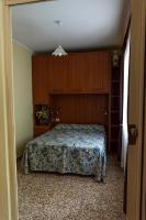 a bedroom with a bed and wooden cabinets at Hotel Villa Ruscello in Baveno